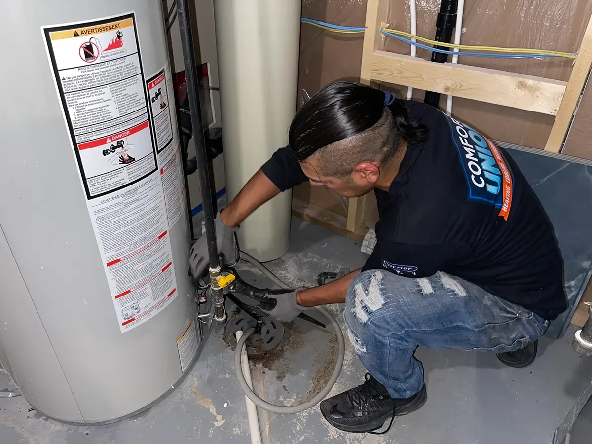 Comfort Union technician performing hot water tank repair to restore safe and efficient service in Chestermere