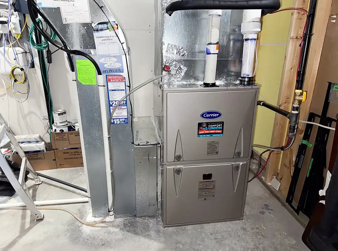Installed Carrier Comfort Series furnace in basement utility room by Comfort Union