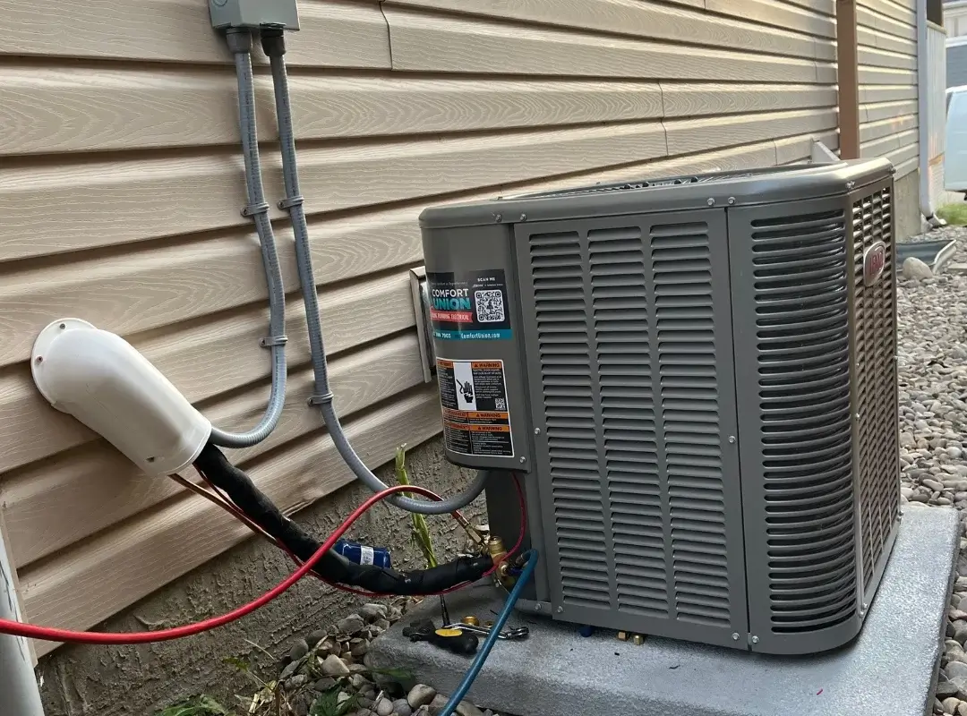 Finished installation of Lennox air conditioner at Chestermere residential home – side view with full wiring visible